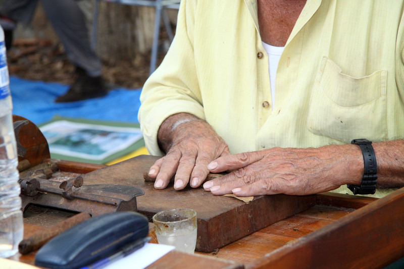 Picture of a Man rolling a Cigar